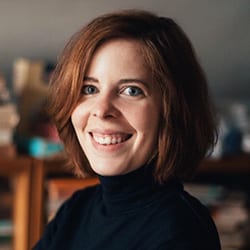 Anna Kmetova PCC CPCC headshot photo, smiling woman wearing black turtleneck