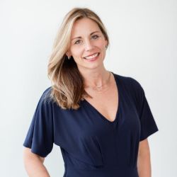Alexa Beavers PCC headshot photo, light haired woman with navy colored top smiling