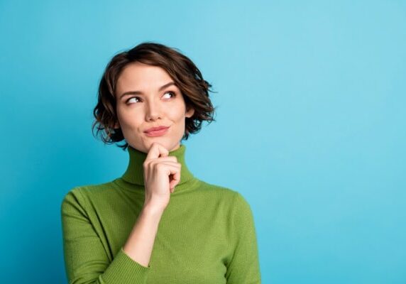 coach pondering in front of a blue background