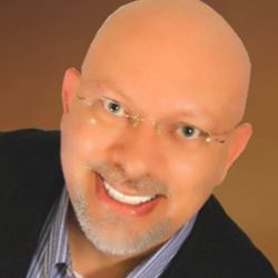 Dr Bradley Davidson PCC headshot photo, bald man smiling wearing glasses