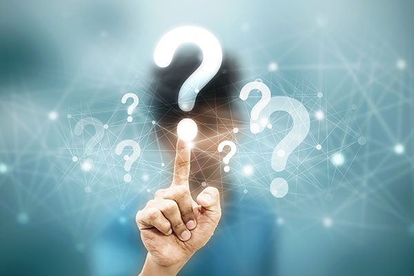 hand touching overlayed question mark surrounded by other question marks and connected dots