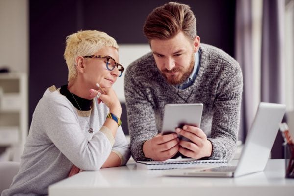 coach and client looking at a small tablet