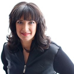 Kim Eusepi headshot photo, smiling woman with dark hair wearing a black top in front of white background