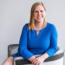 Brittany Salsman PCC headshot photo, smiling woman in blue sitting