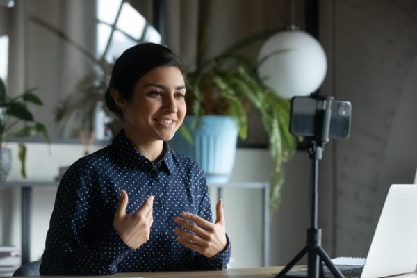 coach filming speaking with a cellphone for use online