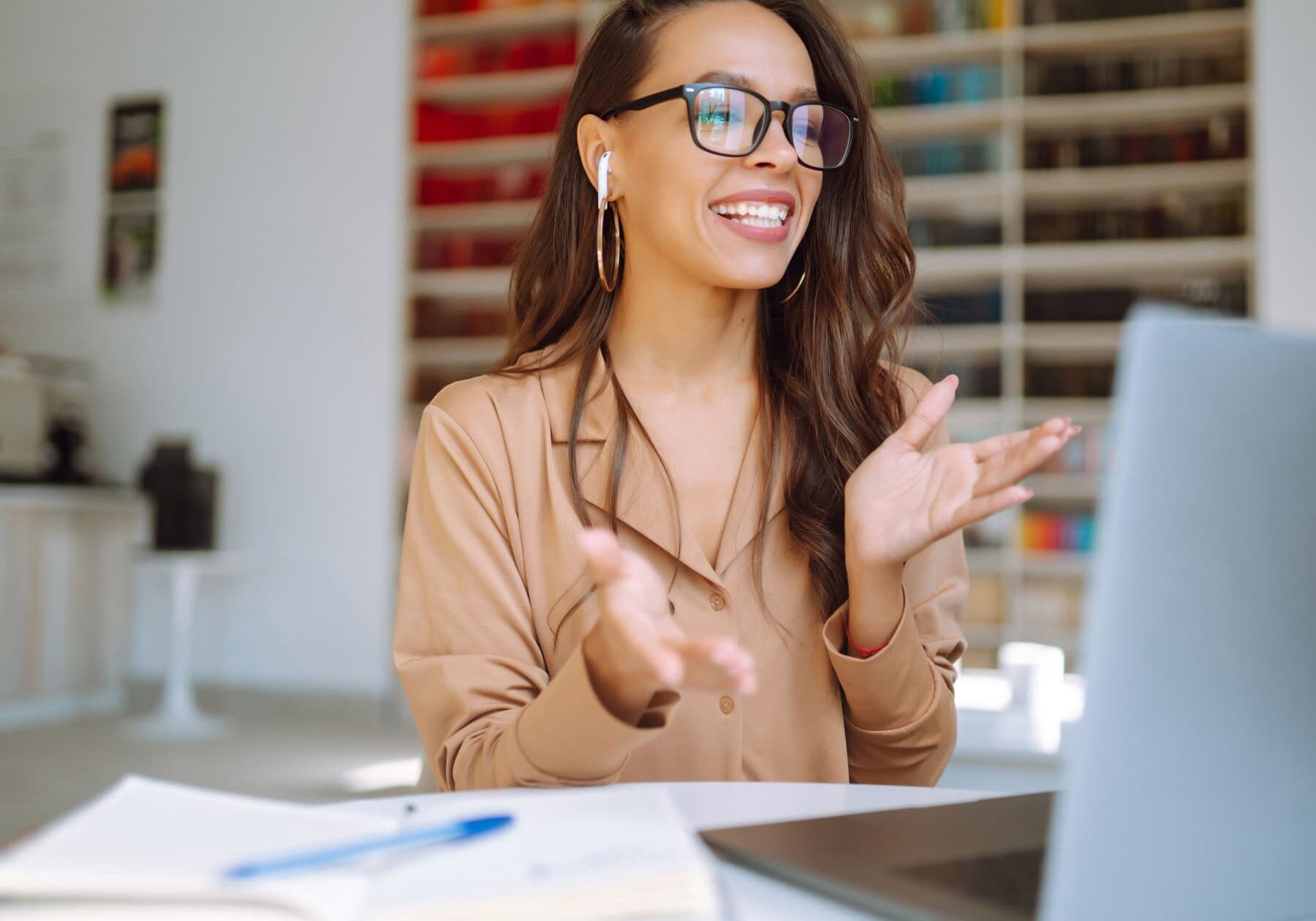 A woman networking through engage on her laptop with other coaches.