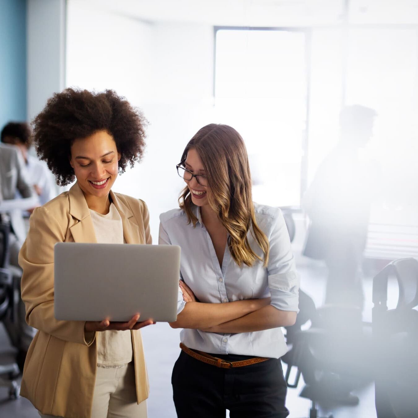 Two women discuss the CCE Accreditation eligibility in an office.