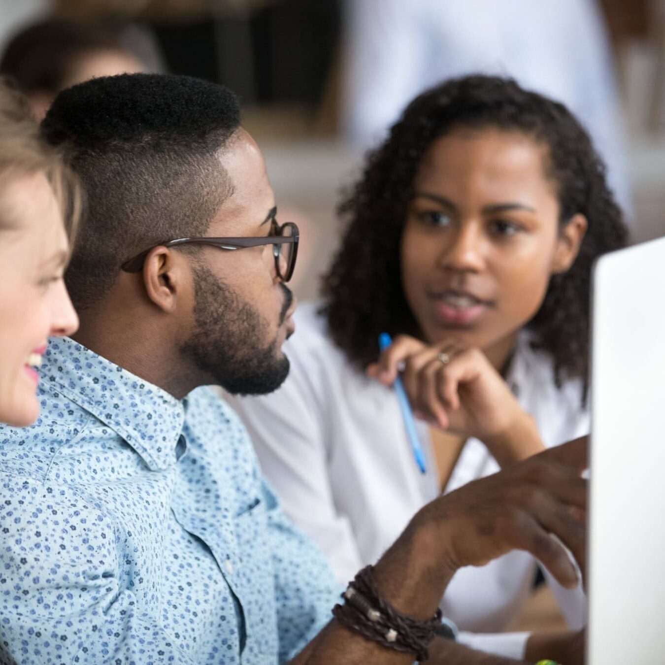 A group of people work on the development of the ACTC exam together.