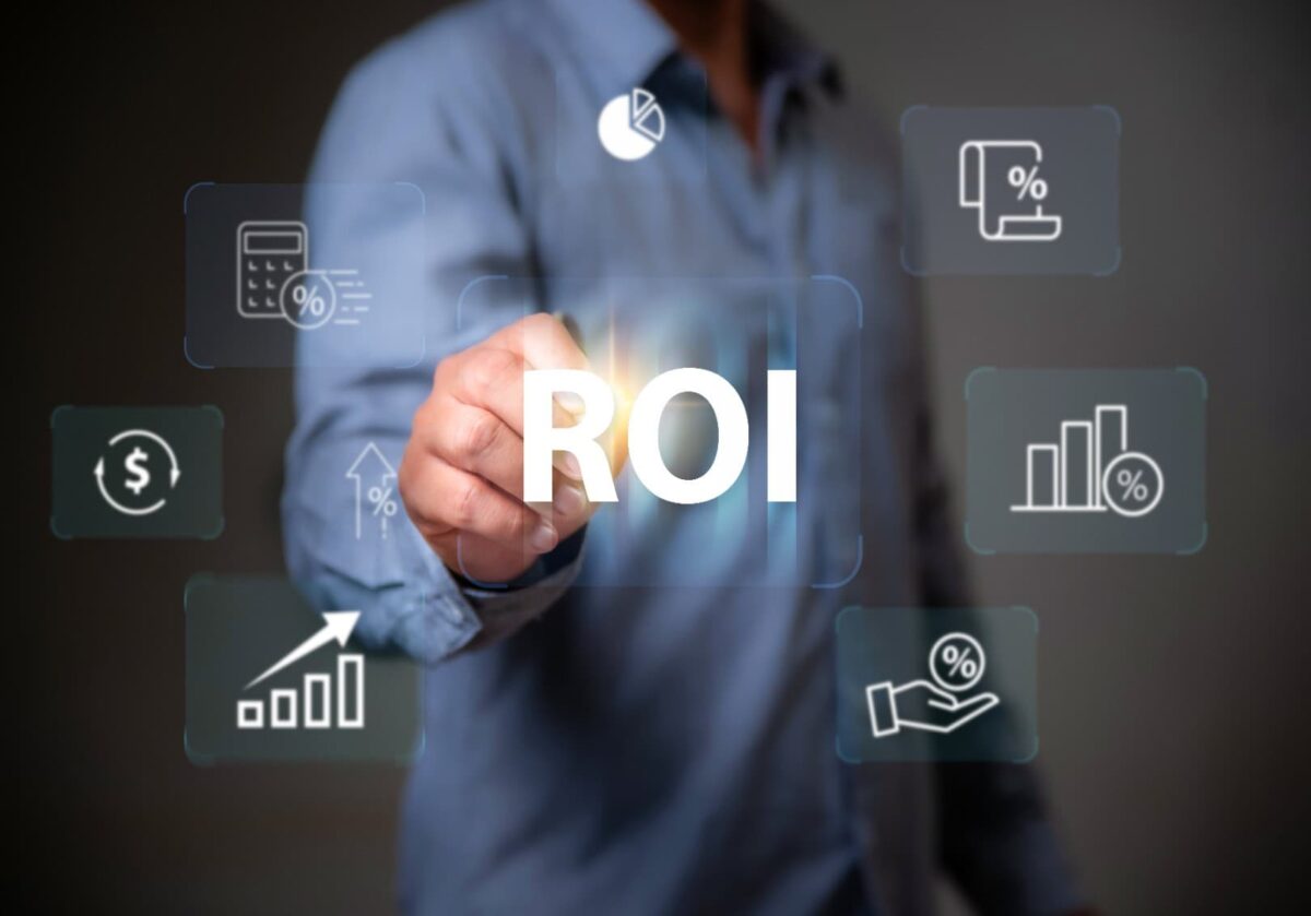 A person touching a holographic 'ROI' (Return on Investment) button surrounded by financial and calculation icons.