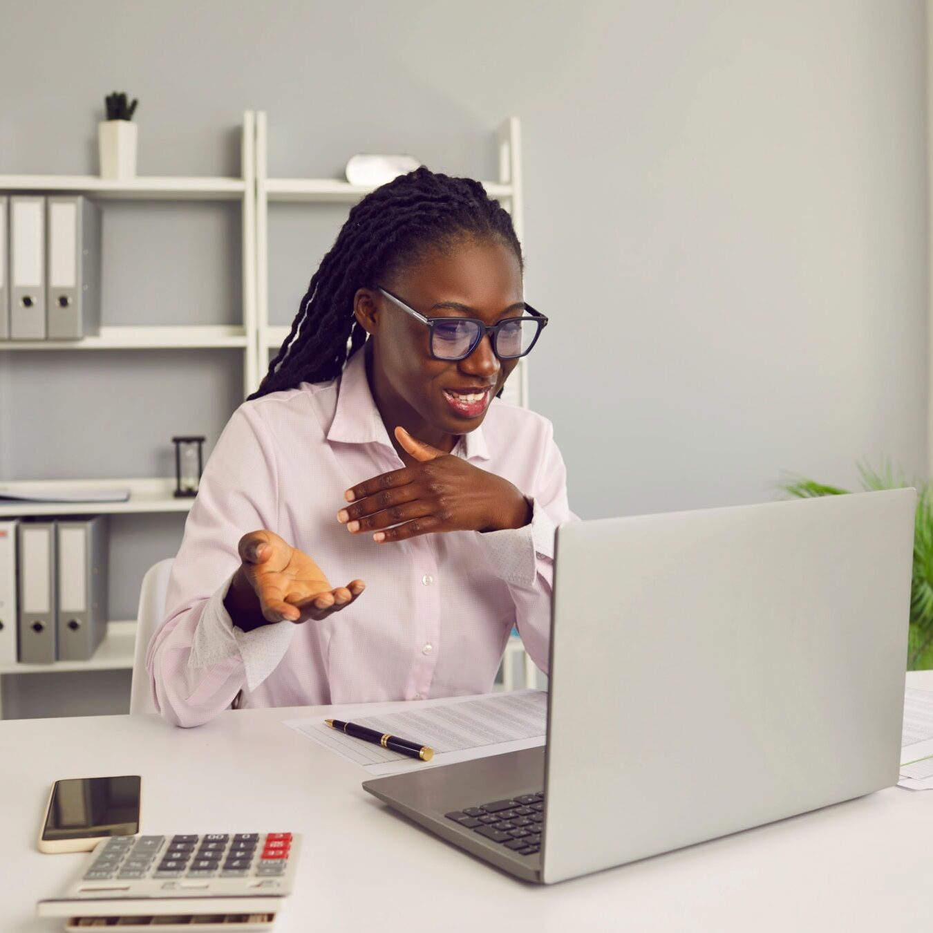 A woman using her computer for various AI related activities in a home office.
