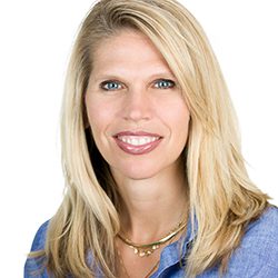 Jennie Antolak MCC headshot photo, blond woman smiling with blue top in front of a white background