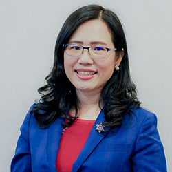 Khanittha Lolak PCC headshot photo, dark haired woman wearing glasses red top and blue blazer smiling
