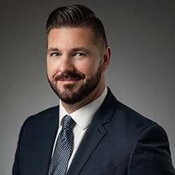 Luke Davis headshot photo, smiling man in suit and tie
