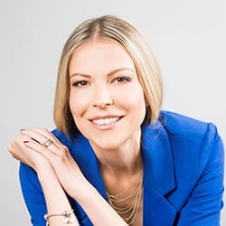 Marina Jankovic MCC headshot photo, smiling blond woman wearing blue blazer
