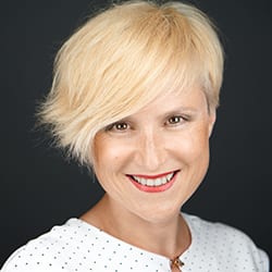 Mojac Korelc headshot photo, blond woman smiling
