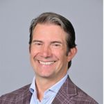 Headshot of Woody Woodward, PCC with the International Coaching Federation. Known for co-founding and leading NYU's Master of Science in Executive Coaching and Organizational Consulting (ECOC) program and expertise in organizational consulting at PricewaterhouseCoopers Consulting (PwC) and project management for IBM Business Consulting Services.