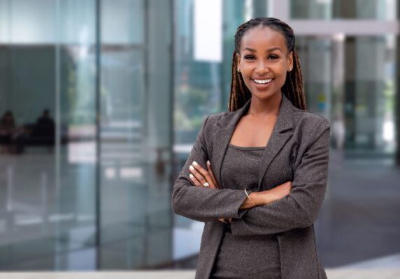 smiling coach standing in front of an office building