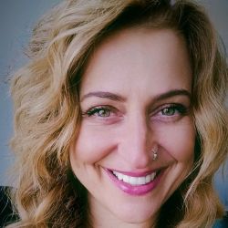 Jennifer Powers MCC headshot photo, woman with blond hair smiling, just showing her head