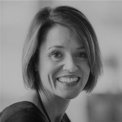 Leah Parkhill Reilly ACC headshot photo, black and white photo of a woman with short hair smiling