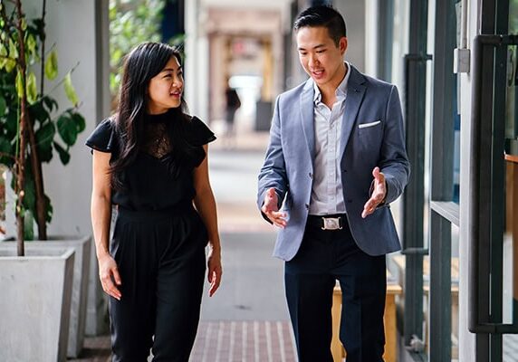 a coach and client walking and talking engaged respectfully