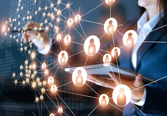 person working at a transparent screen with a map of many connected people icons signifying connecting with professionals on social media