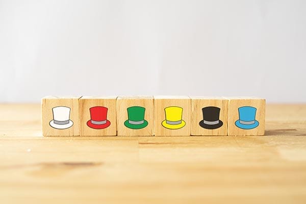 blocks lined up with different colored hats printed on them