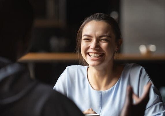woman laughing and connecting with her coach