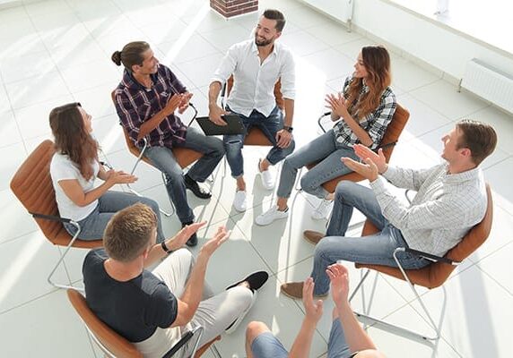 group coaching session with people positively engaged and interacting in the conversation