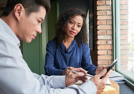 woman supervising man using a cellphone