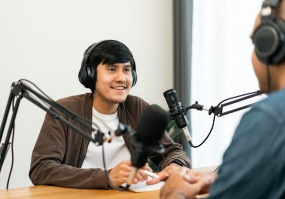 two men speaking and recoding audio with microphones
