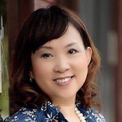 Wanpen Visanbuchanee PCC headshot photo, smiling woman with dark hair and blue top