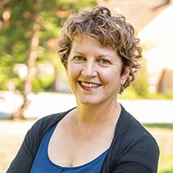 Wendy Edelstein PCC CPCC MA headshot photo, smiling woman outside with curly brown hair