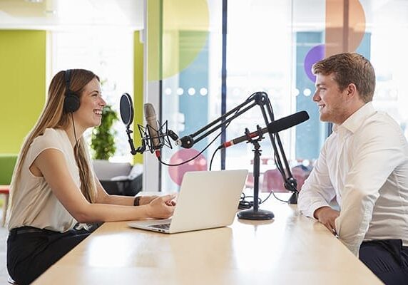 two people at a table recording a podcast