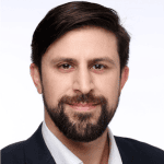 Headshot of Yiannis Kontou, MCC and Credentials and Standards Board member with the International Coaching Federation. Known for advancing coaching standards and driving innovation.